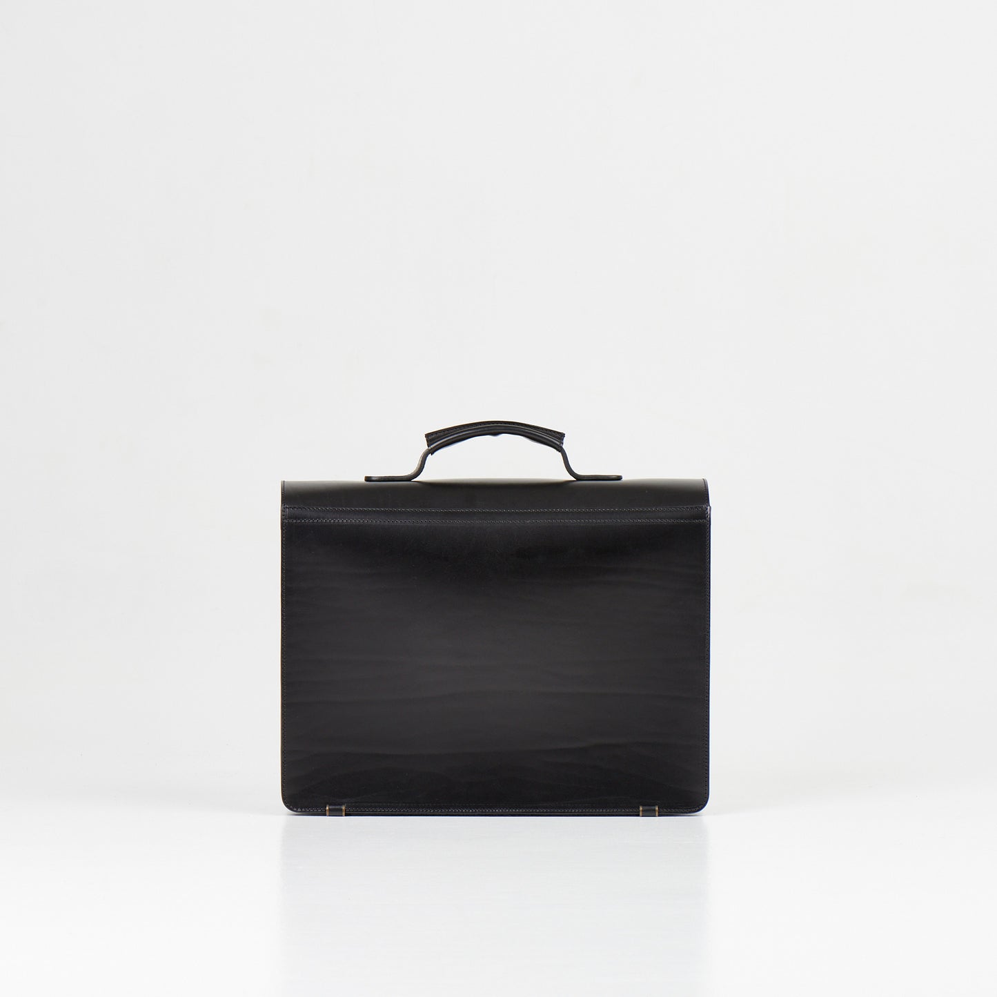 Papillon black artisan leather business bag with top handle and sleek design