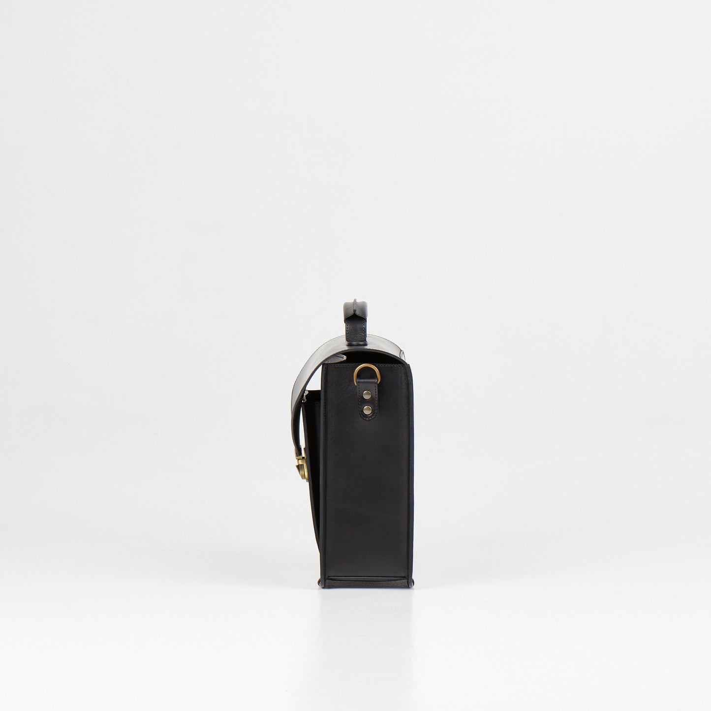Side view of Papillon artisan leather business bag in black with metal hardware and shoulder strap