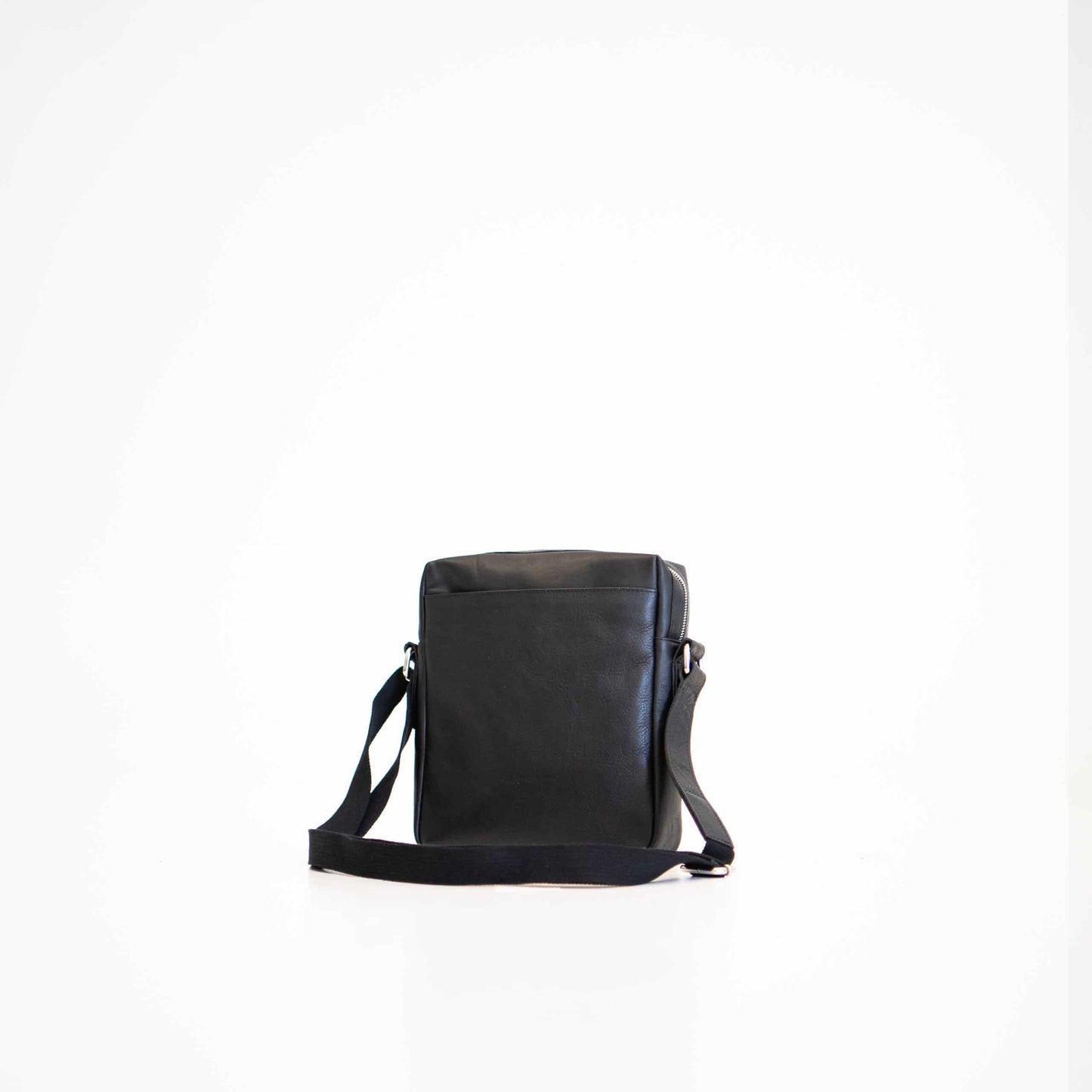 Black small shoulder bag by Papillon with adjustable strap and minimalist design