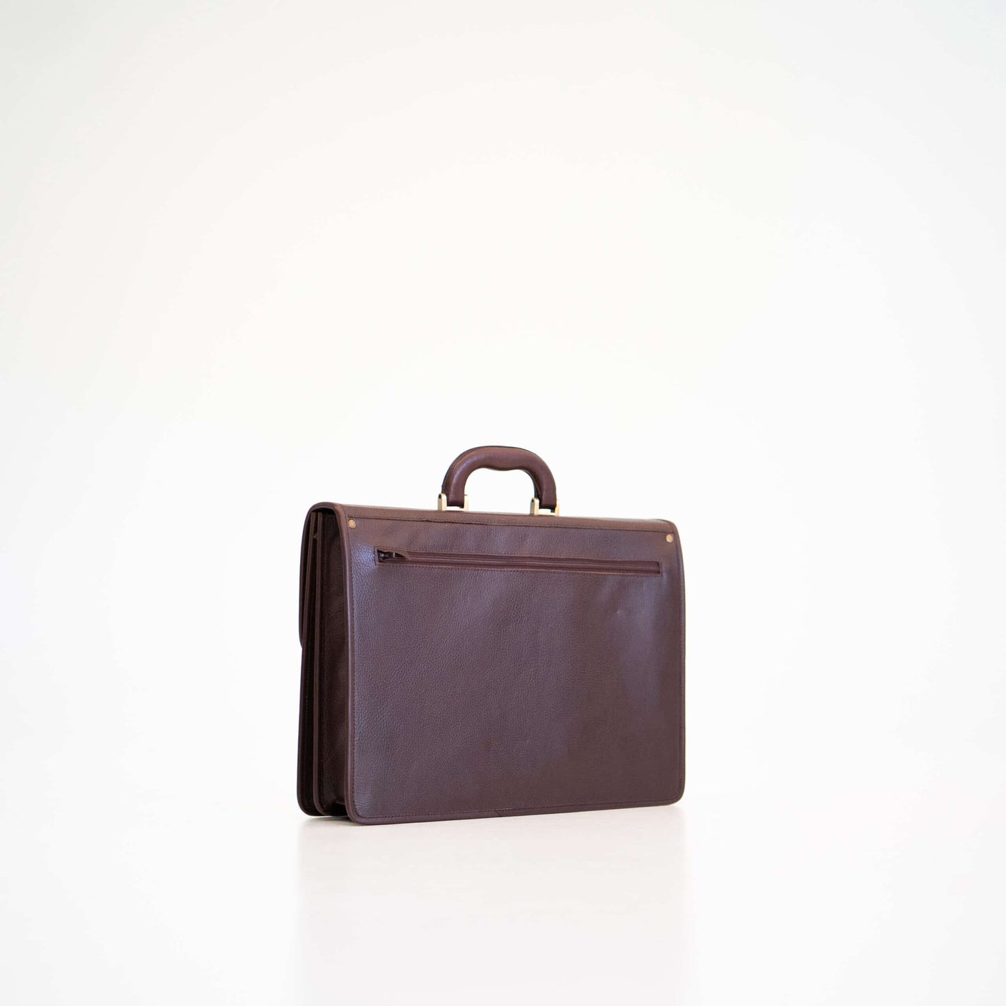 Papillon dark brown leather briefcase with top handle and external zippered pocket on white background