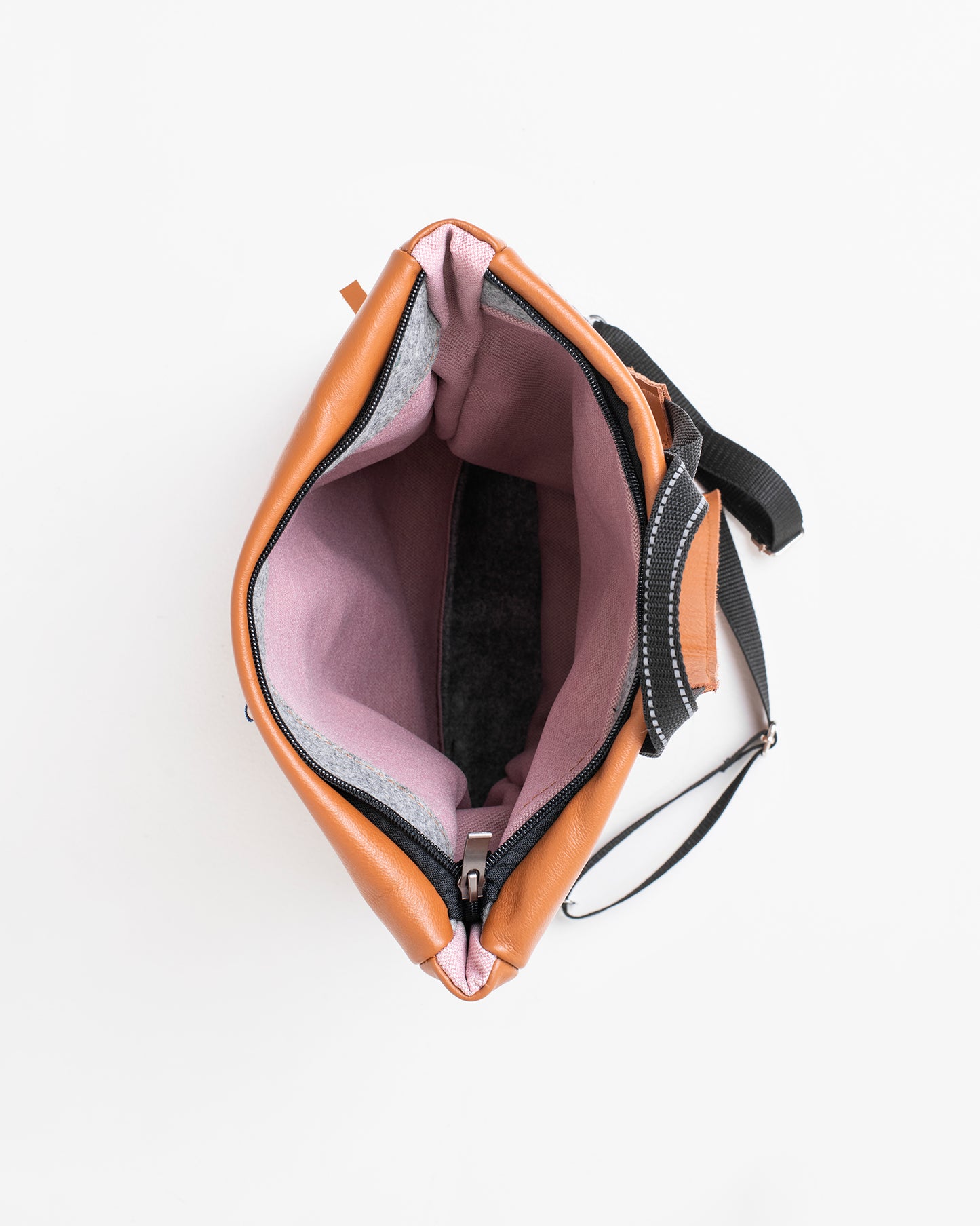 Open peanut leather backpack by Trendbag showing spacious pink interior and black adjustable straps