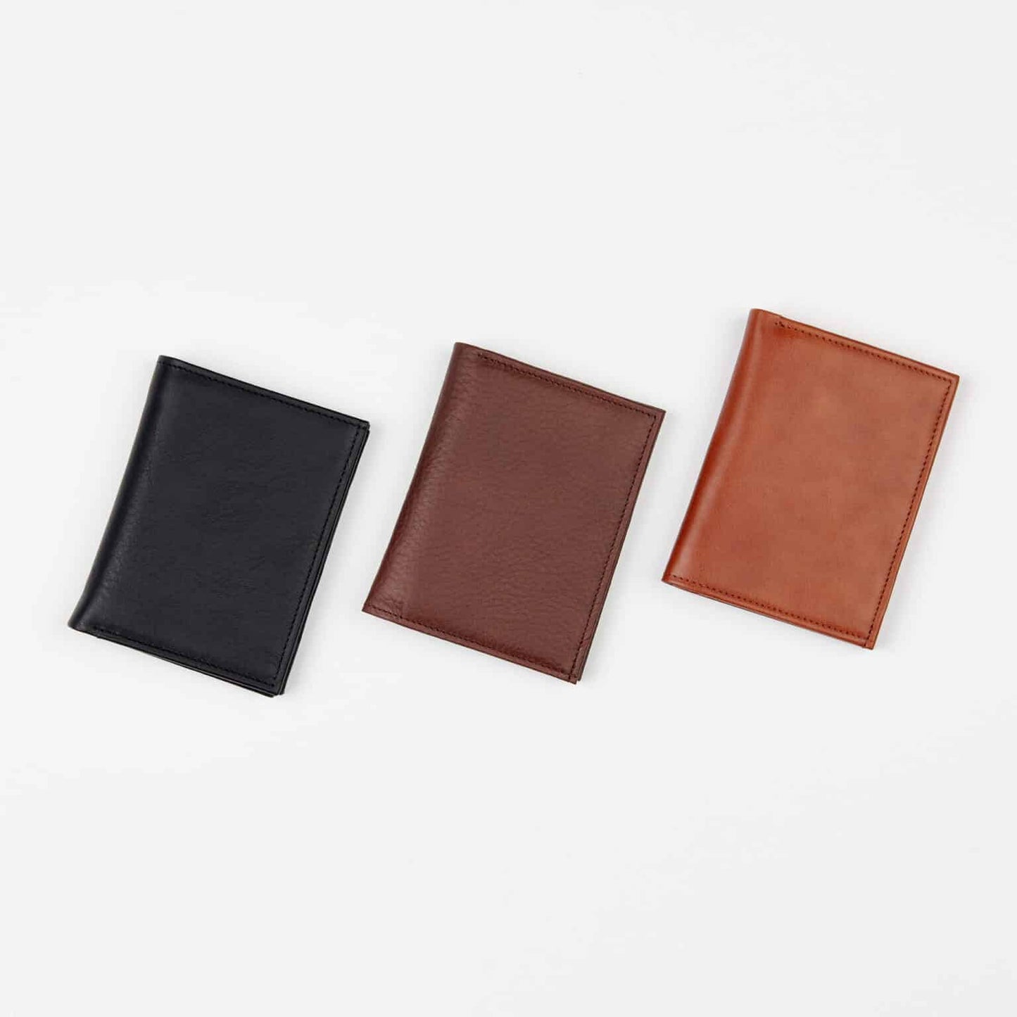 Papillon slim brown leather wallet for men in brown alongside black and tan leather wallets