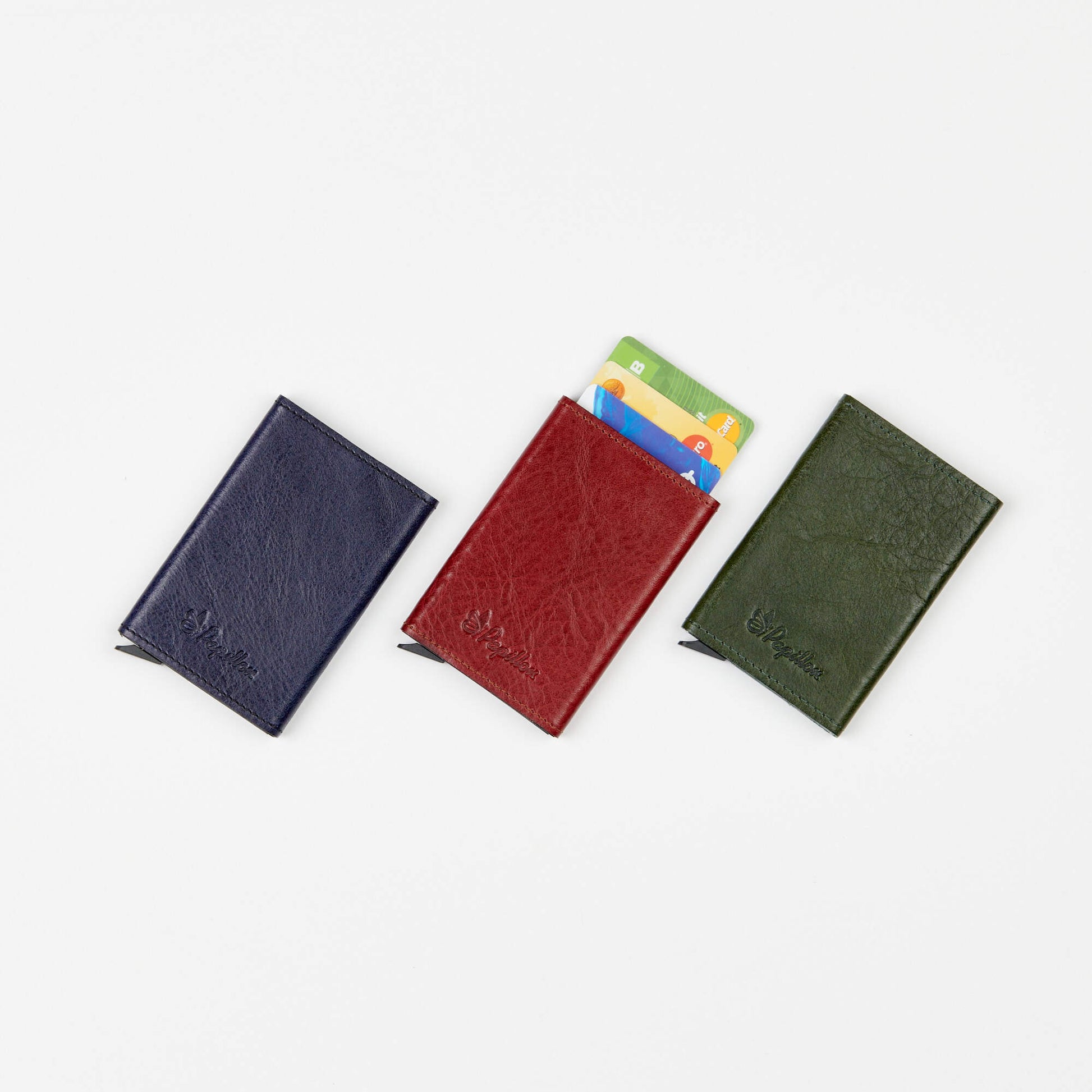 Papillon aluminum leather card holder in navy blue red and green with credit cards inside