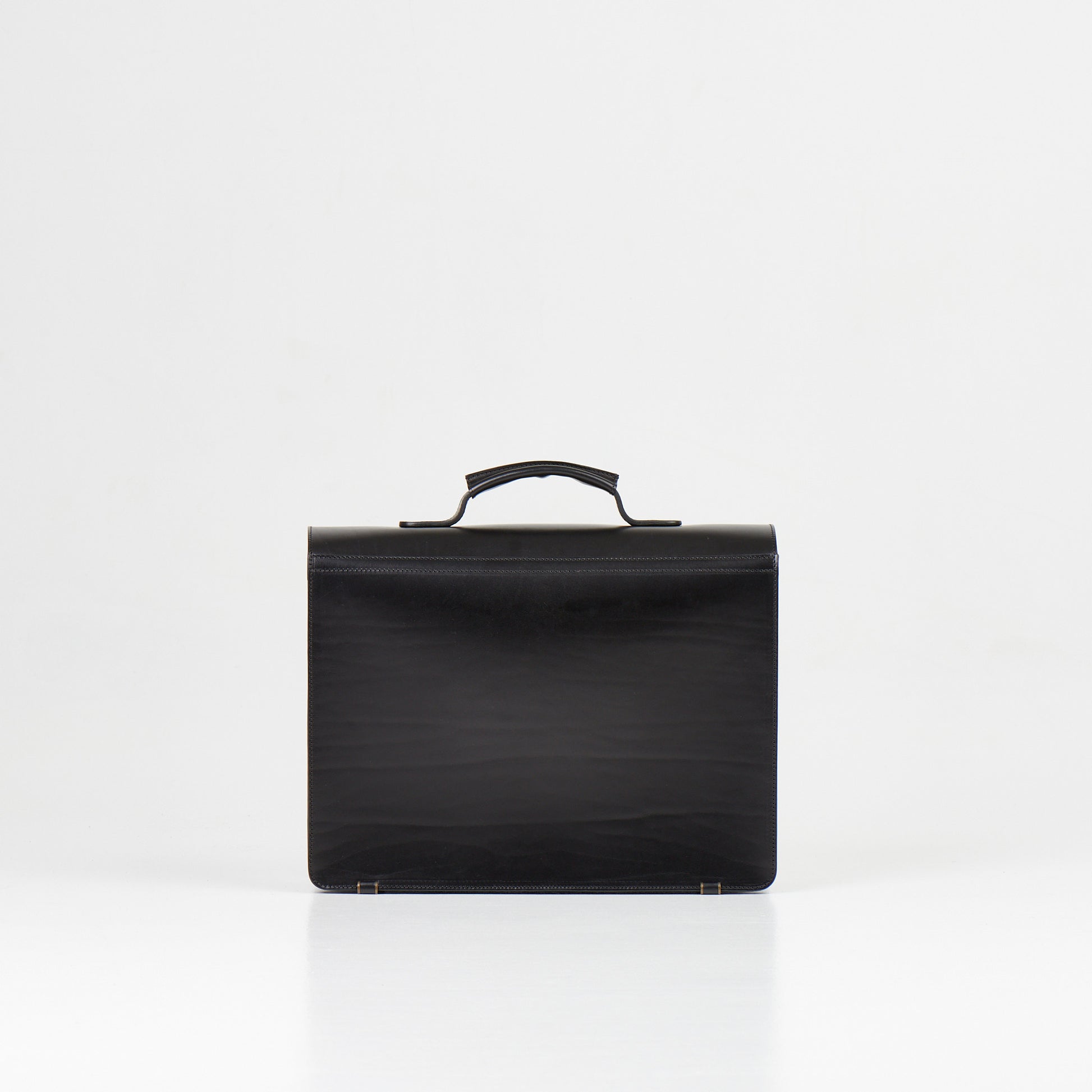 Papillon black artisan leather business bag with top handle and sleek design