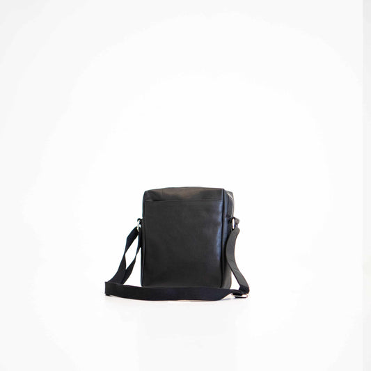 Black small shoulder bag by Papillon with adjustable strap and minimalist design