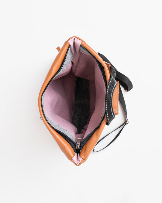 Open peanut leather backpack by Trendbag showing spacious pink interior and black adjustable straps