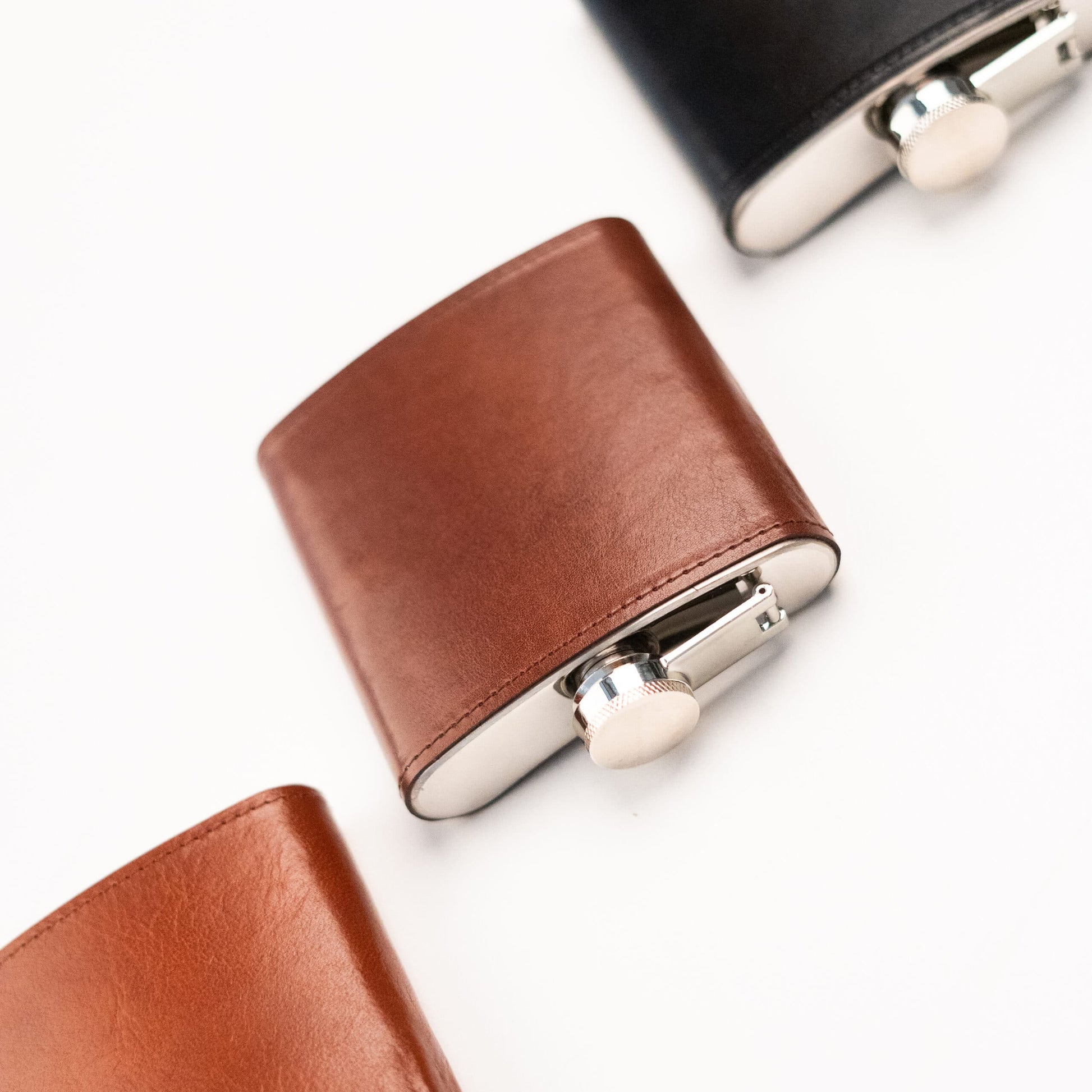 Papillon stylish pocket flask with brown leather cover and silver cap on white background