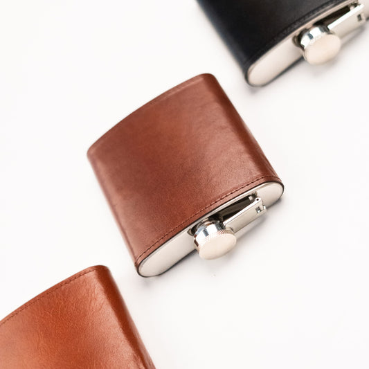 Papillon stylish pocket flask with brown leather cover and silver cap on white background