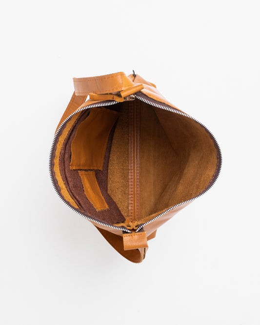 Open caramel leather shoulder bag showing spacious interior and zipper closure from Trendbag