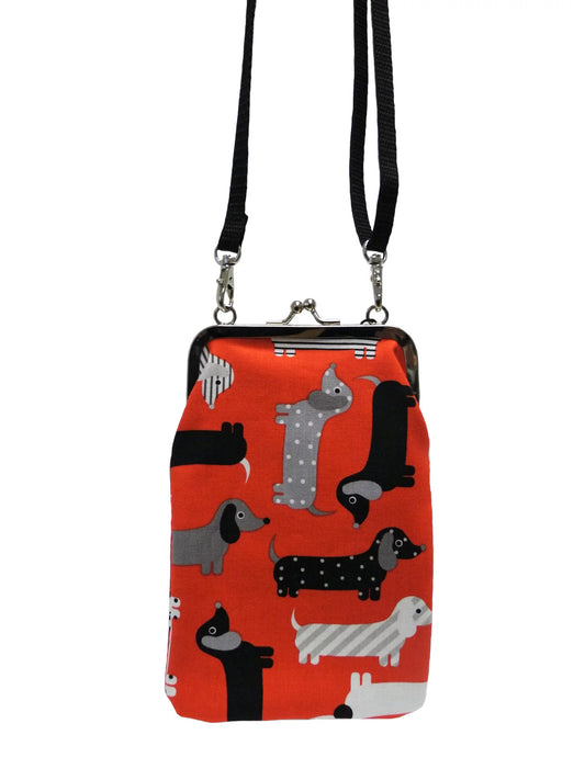 Nabo retro clasp phone pouch with red fabric and playful dog pattern with black strap